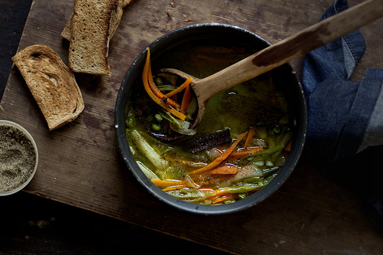 Close-up of hot Indian veg soup with colorful chopped vegetables