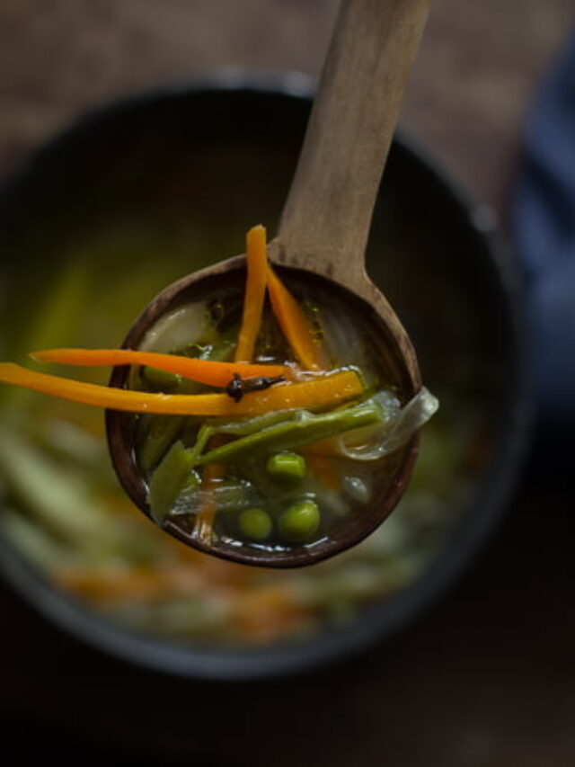 Close-up of hot Indian veg soup with colorful chopped vegetables