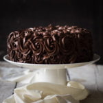 A whole Tiramisu Cake garnished with chocolate curls