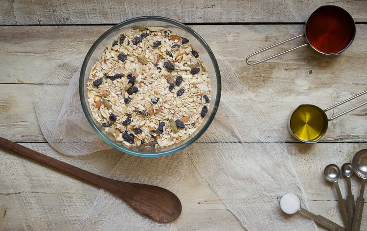 A top-down view of homemade granola with cranberries and pecans