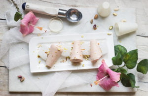 A close-up of a creamy Strawberry Malai Kulfi on a stick