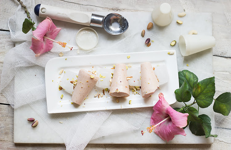 A close-up of a creamy Strawberry Malai Kulfi on a stick