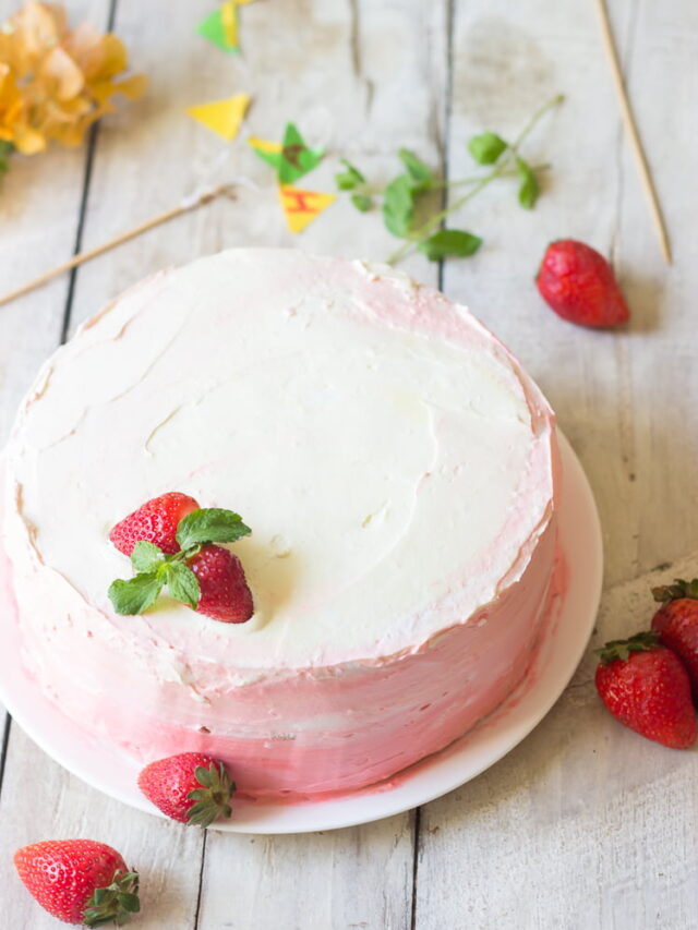 Frosting being applied to the outer layer of the Eggless Strawberry Ombre Cake