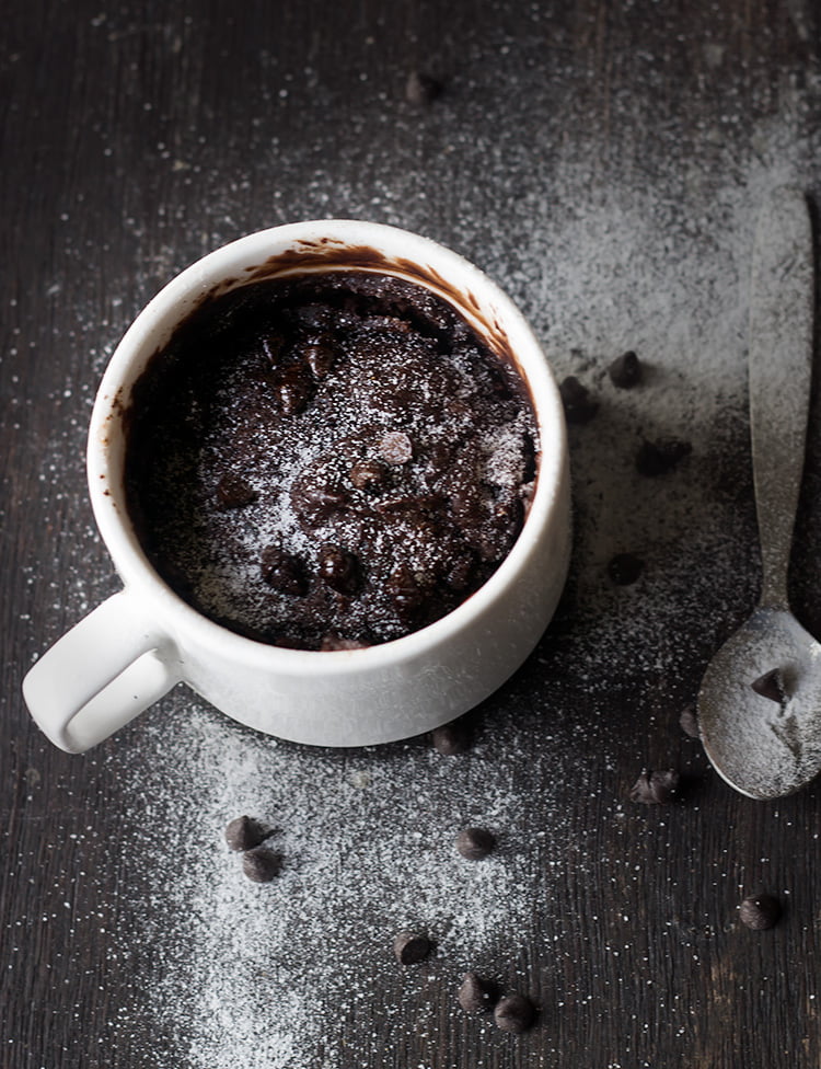 Top view of fudgy mug brownie with powdered sugar dusting.