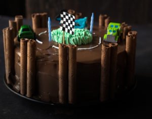 Detailed view of the intricate designs and decorations on the race track birthday cake