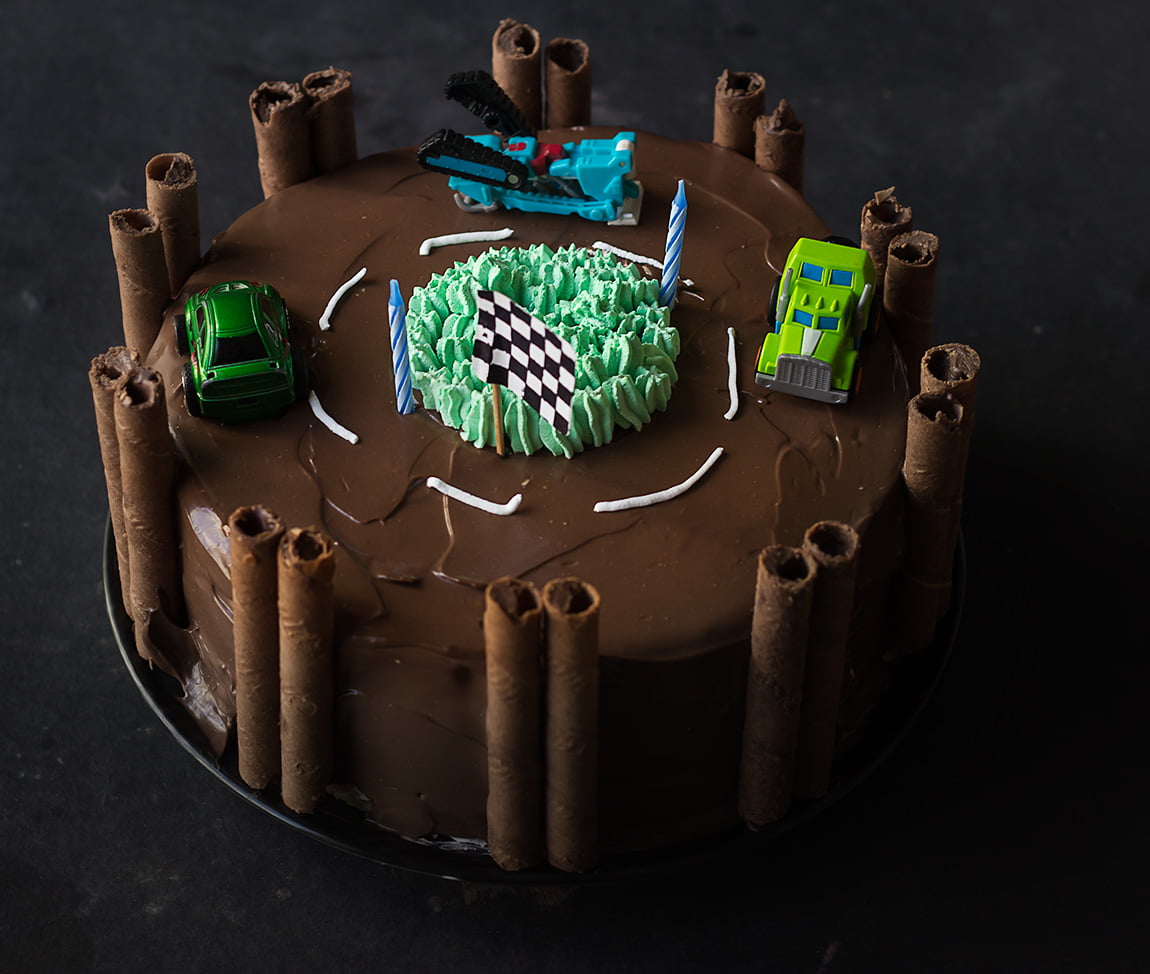 Detailed view of the intricate designs and decorations on the race track birthday cake
