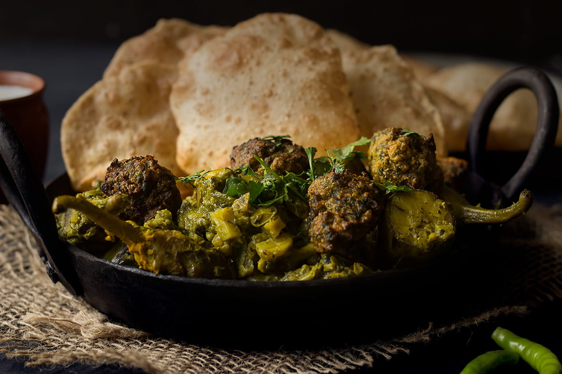 Traditional Surti Undhiyu served with puris