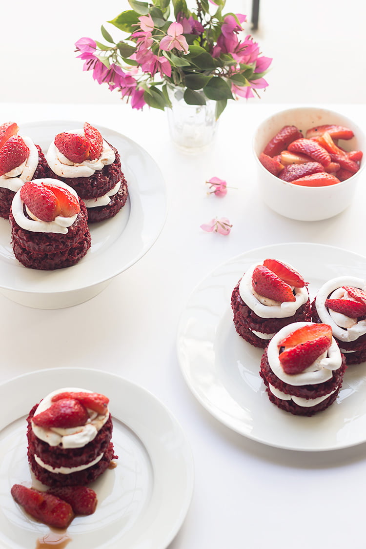Overhead shot of red velvet mini cakes arranged on a white platter