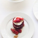 Close-up of a freshly baked eggless red velvet mini cake with cream cheese frosting