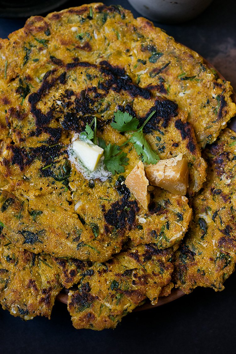 Traditional Punjabi-style meal setup featuring Makke ke Paranthe