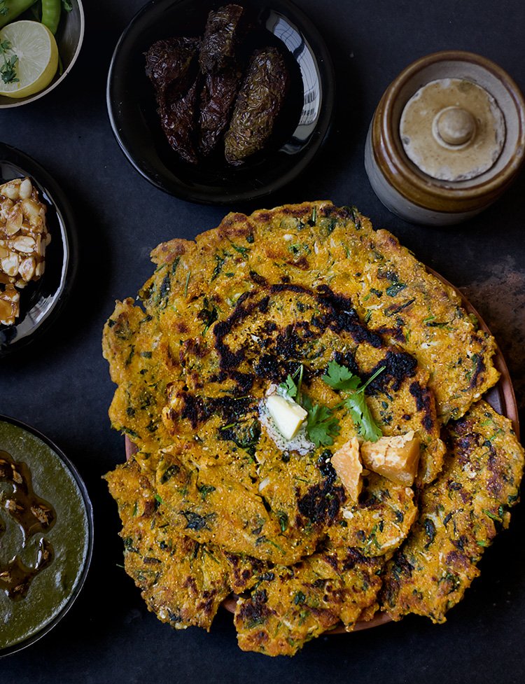 Close-up of golden-brown Makke ke Paranthe served on a plate with butter