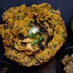 Traditional Punjabi-style meal setup featuring Makke ke Paranthe