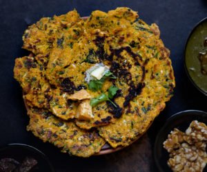 Traditional Punjabi-style meal setup featuring Makke ke Paranthe