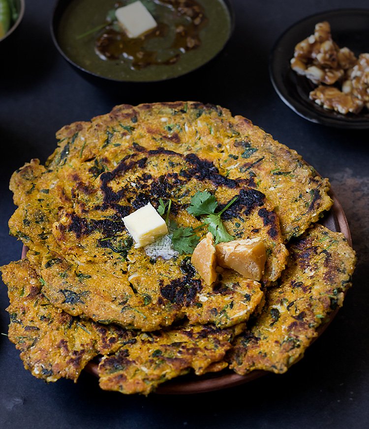 Makke ke Paranthe served with pickles and fresh green chilies