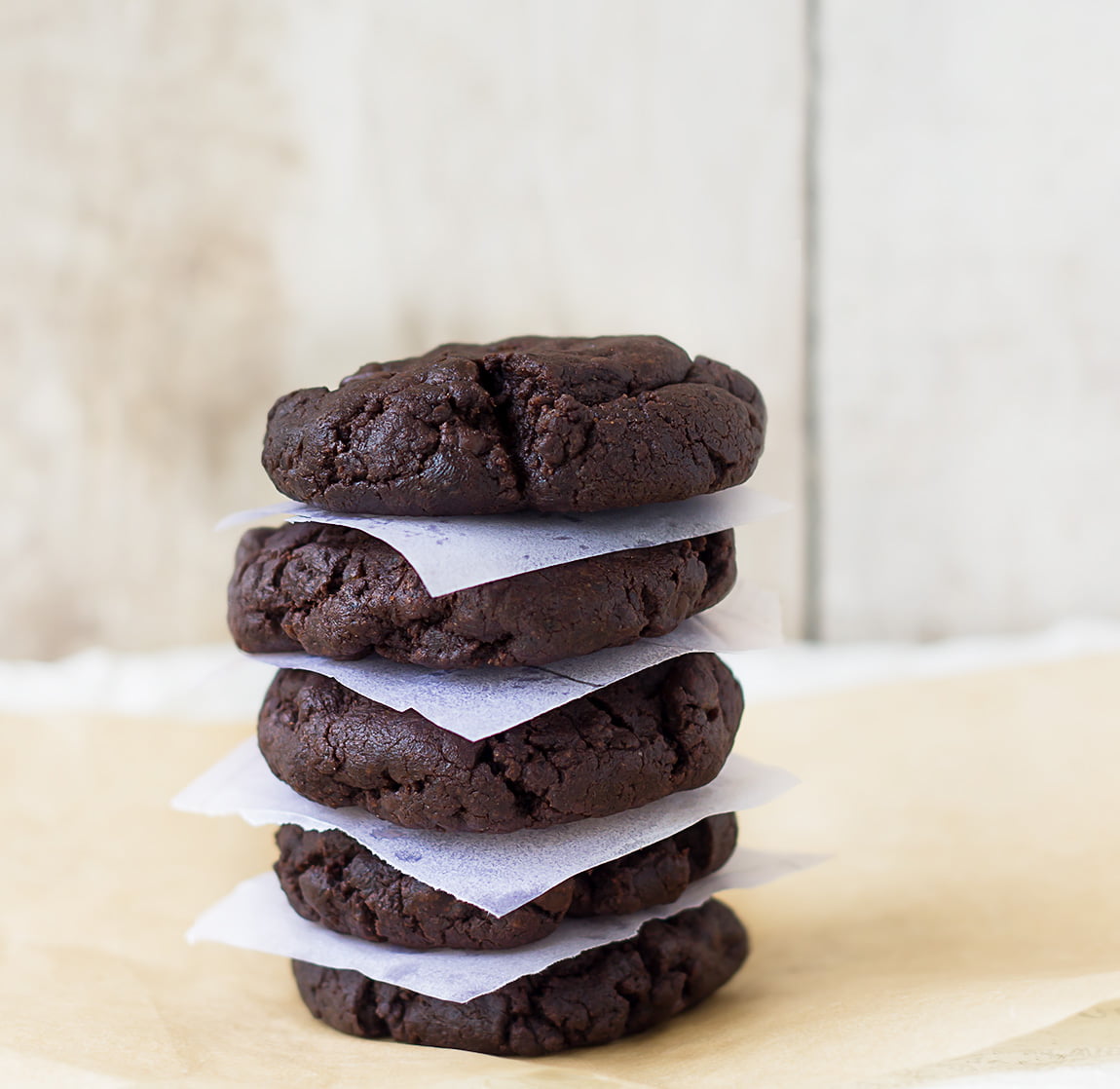 Double chocolate chip cookies arranged on a wooden board for serving
