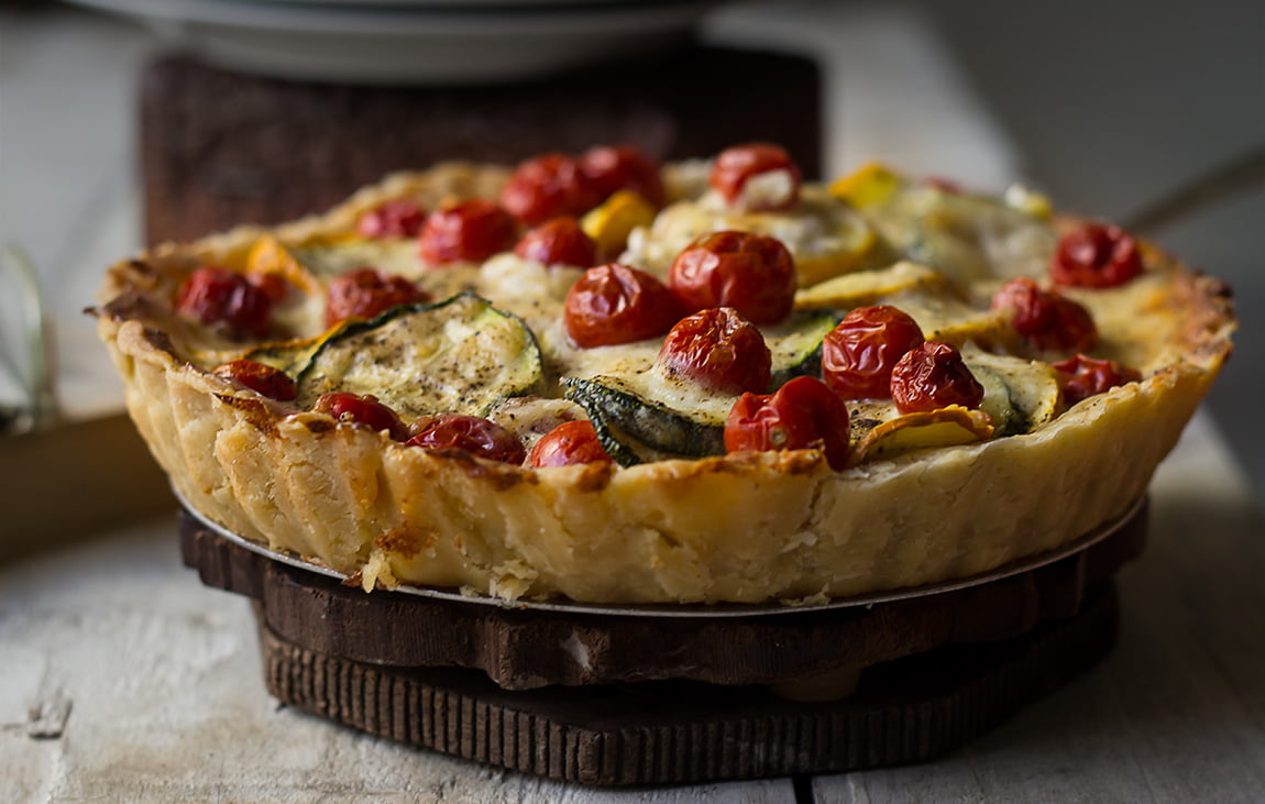 Tomato Zucchini Tart placed on a plate, ready to serve
