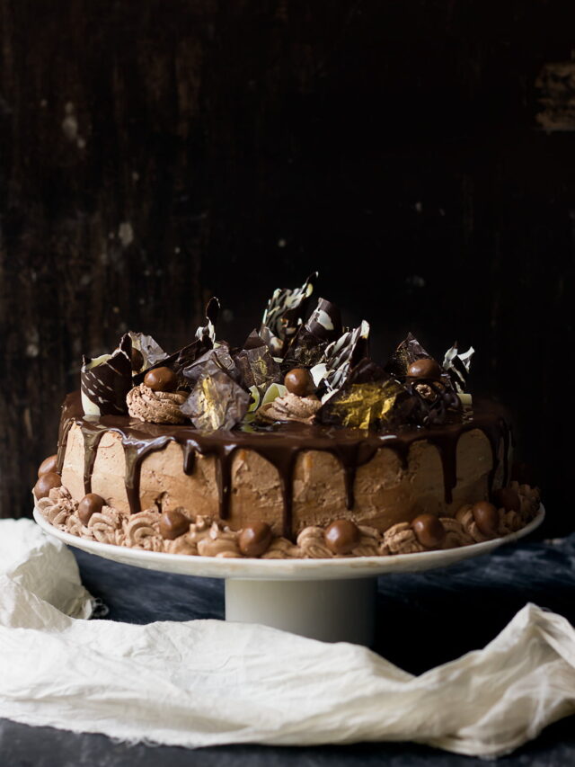 Close-up of garnishing the cake with chocolate shavings and nuts
