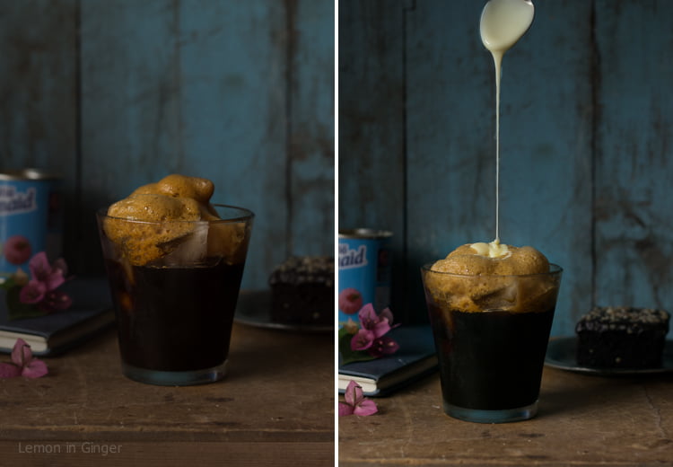 A glass of iced coffee on a wooden table with a spoon
