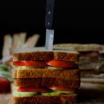 Fresh tomato cucumber sandwich served on a white plate