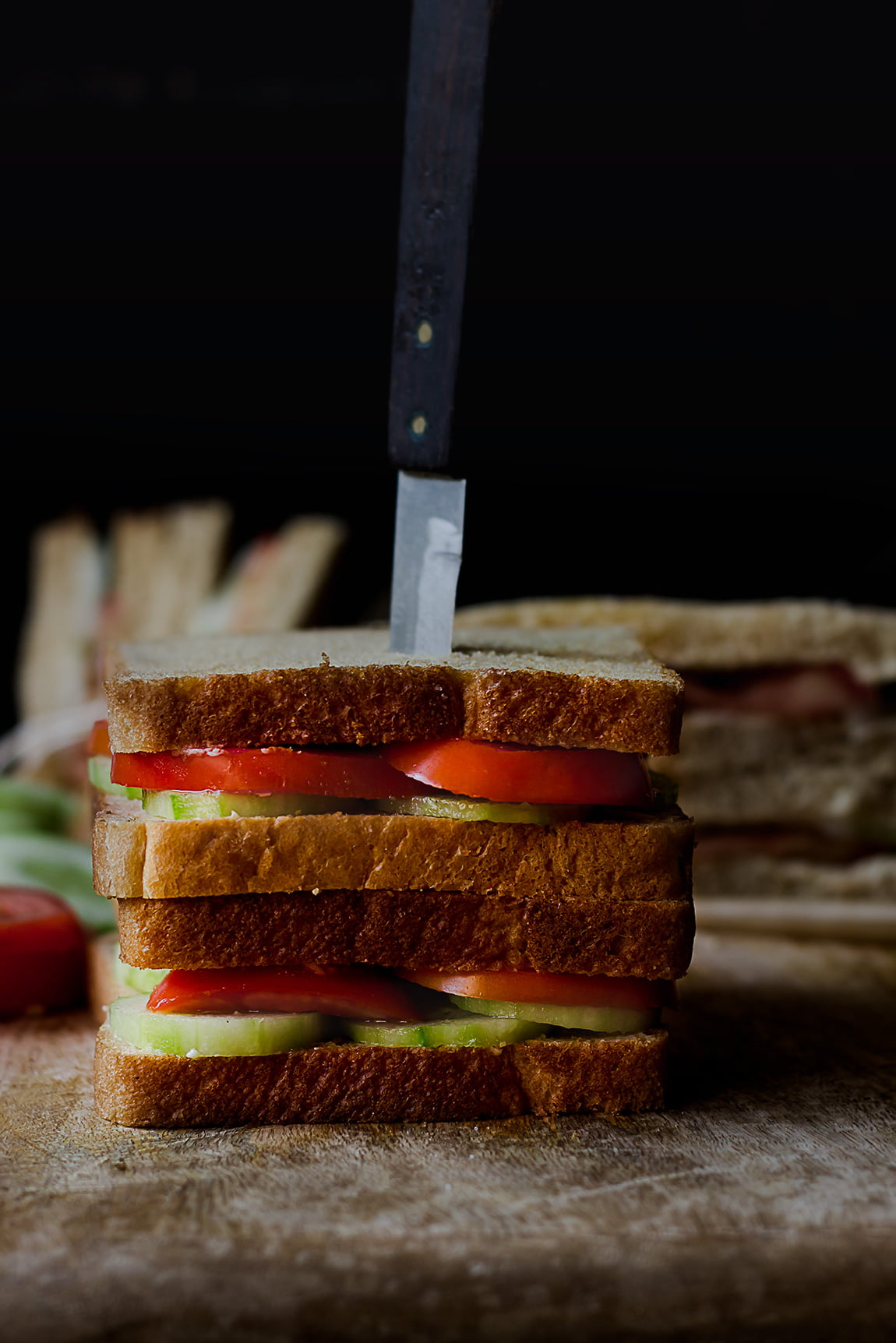 Fresh tomato cucumber sandwich served on a white plate