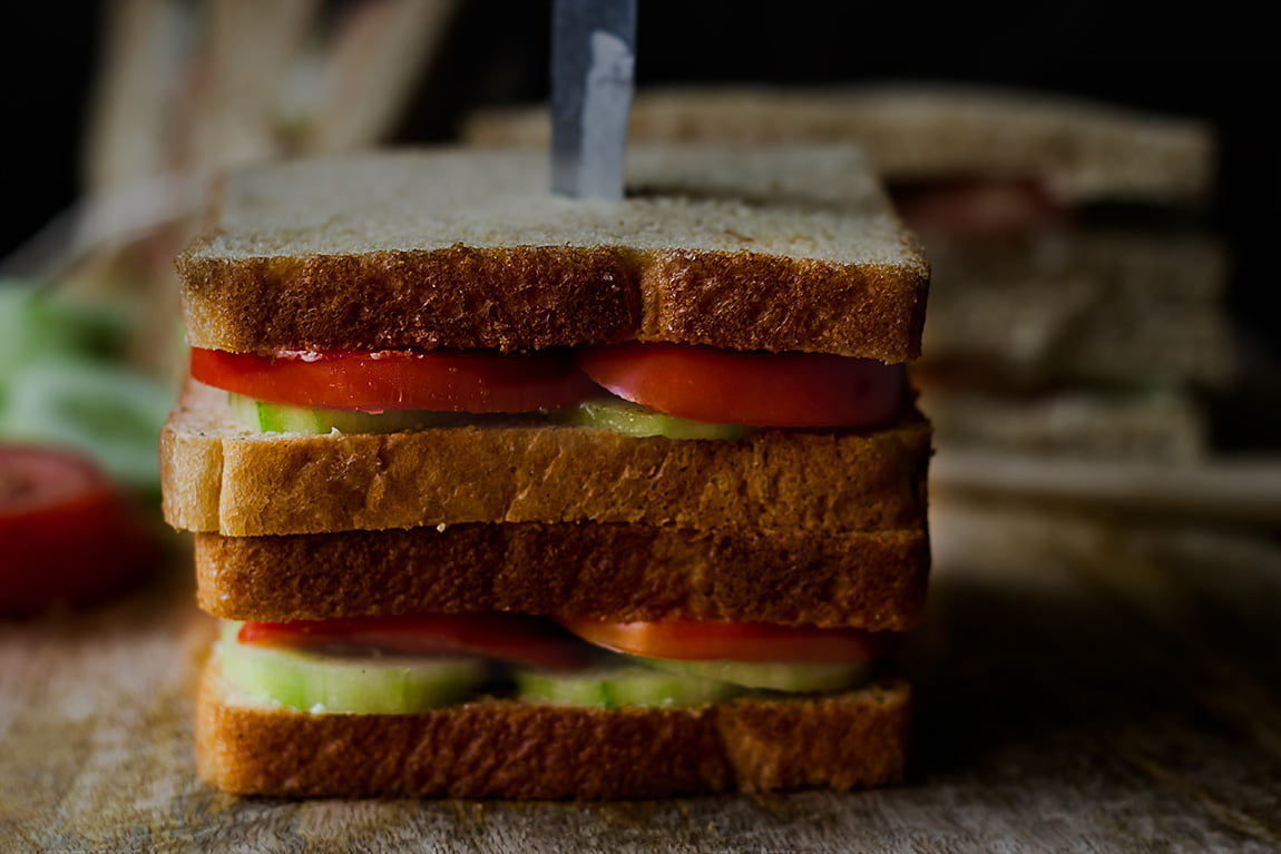Close-up of tomato cucumber sandwich with green chutney