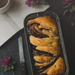 Golden-brown Chocolate Babka loaf fresh out of the oven, glistening with syrup