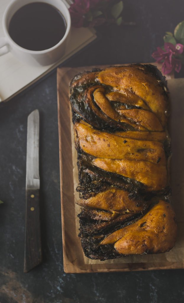 Top view of a braided Chocolate Babka loaf on a cooling rack