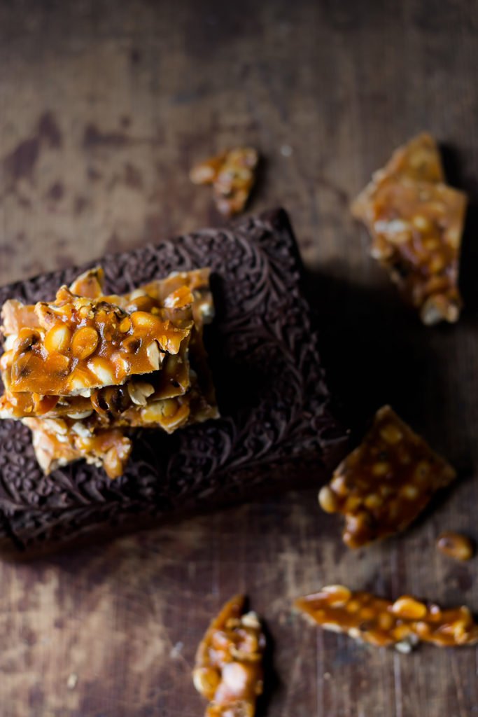 Close-up shot showing the texture of peanut brittle with visible nuts
