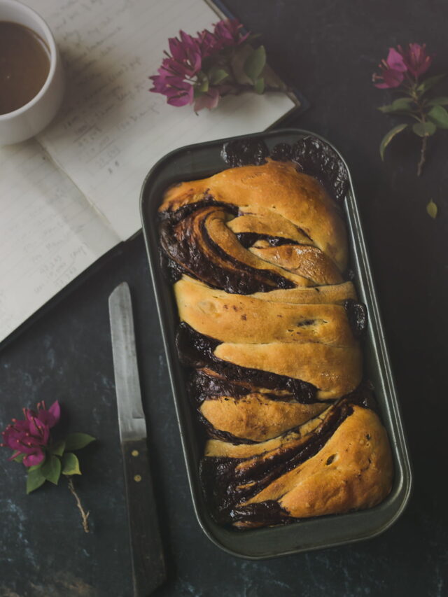 Golden-brown Chocolate Babka loaf fresh out of the oven, glistening with syrup
