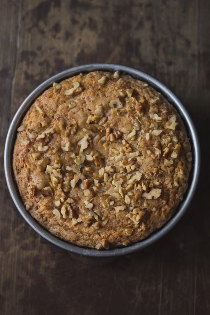 Close-up of the cake’s texture, showing grated carrots and cinnamon specks
