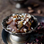 A bowl of freshly made Aate Ka Halwa garnished with almonds and pistachio