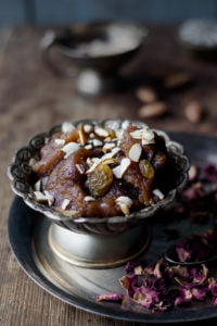 A bowl of freshly made Aate Ka Halwa garnished with almonds and pistachio