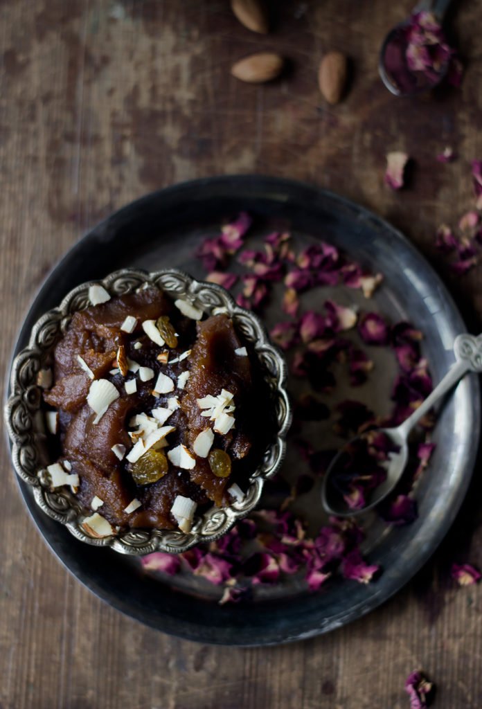 A bowl of freshly made Aate Ka Halwa garnished with almonds and pistachio