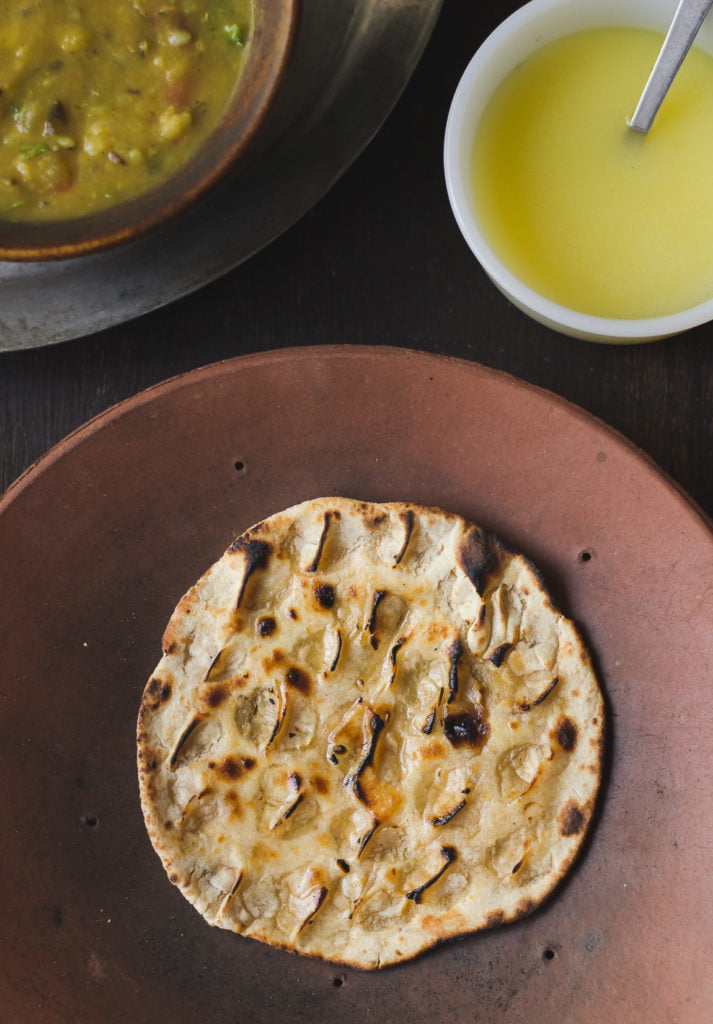 Khoba roti with ghee melting on top served with dal and chutney
