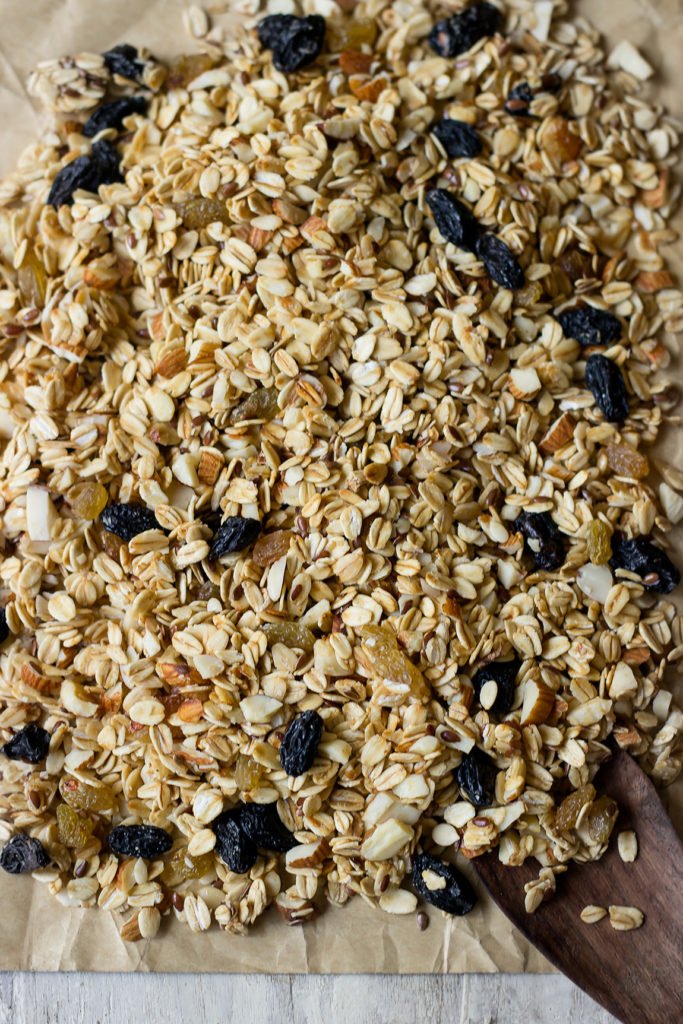A healthy granola mix spread on a tray before going into the oven