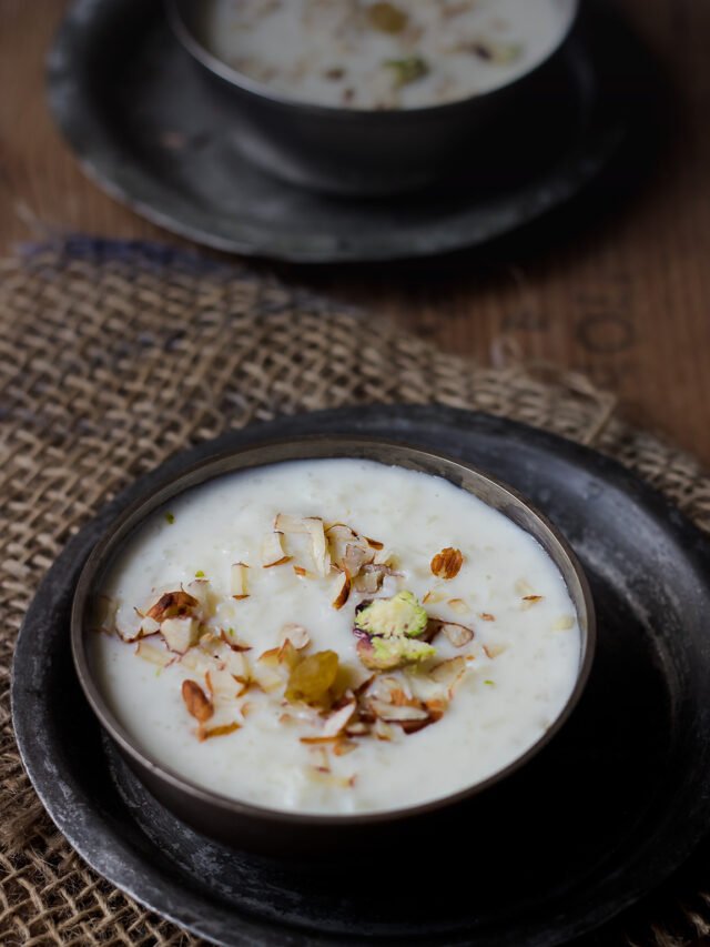 A bowl of creamy rice kheer garnished with almonds and saffron