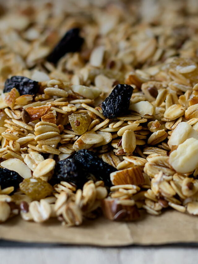 Freshly baked healthy granola on a baking tray lined with parchment paper