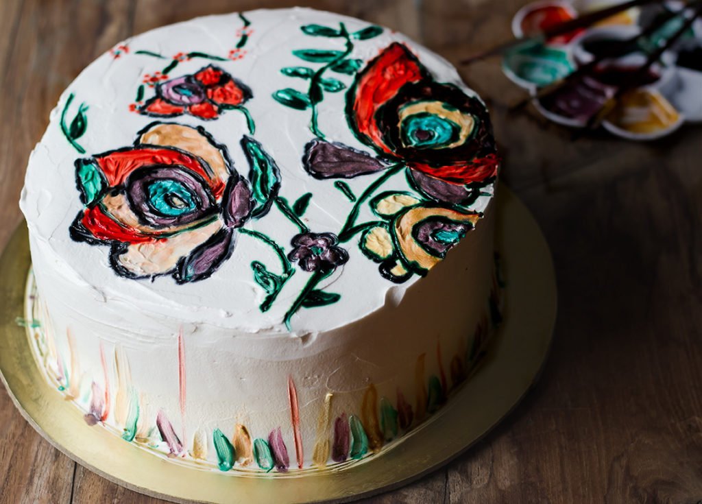 A close-up of a beautifully decorated moist and fluffy eggless hand-painted cake