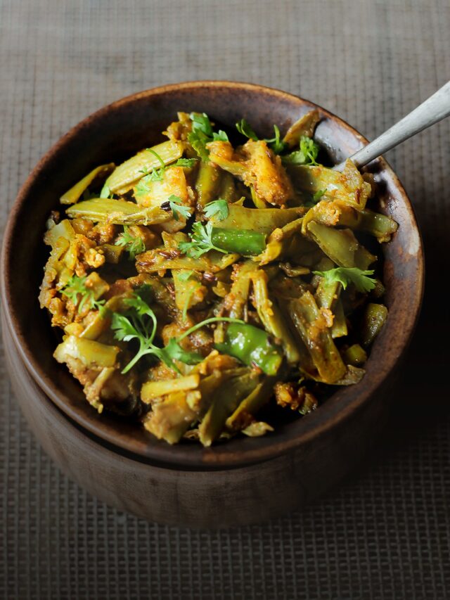 A bowl full of freshly cooked Gawar Phali Ki Sabji, garnished with cilantro