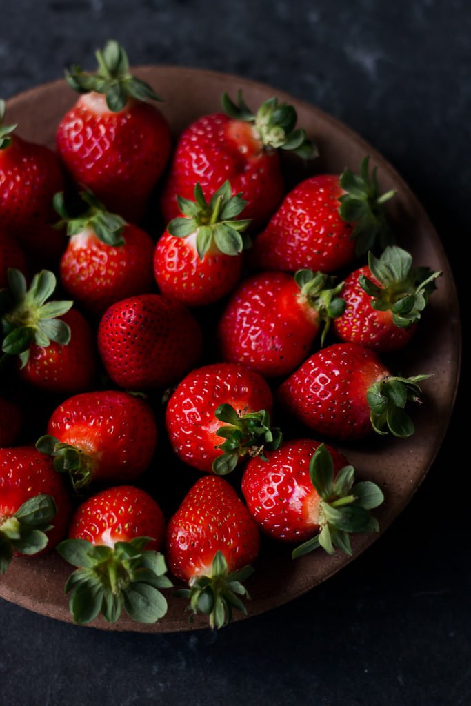 Fresh strawberries arranged in a container, ready to enjoy