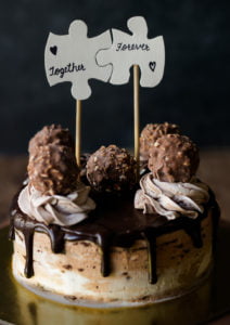A beautifully decorated Eggless Ferrero Rocher Cake topped with whipped cream