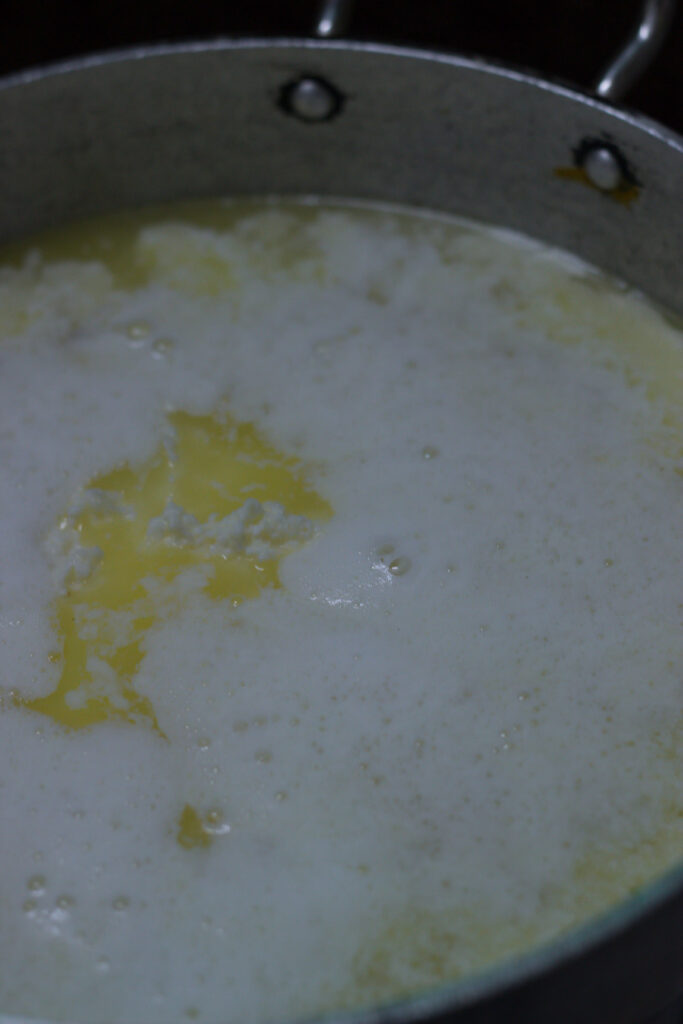 Butter cubes melting in a pan, beginning the ghee-making process