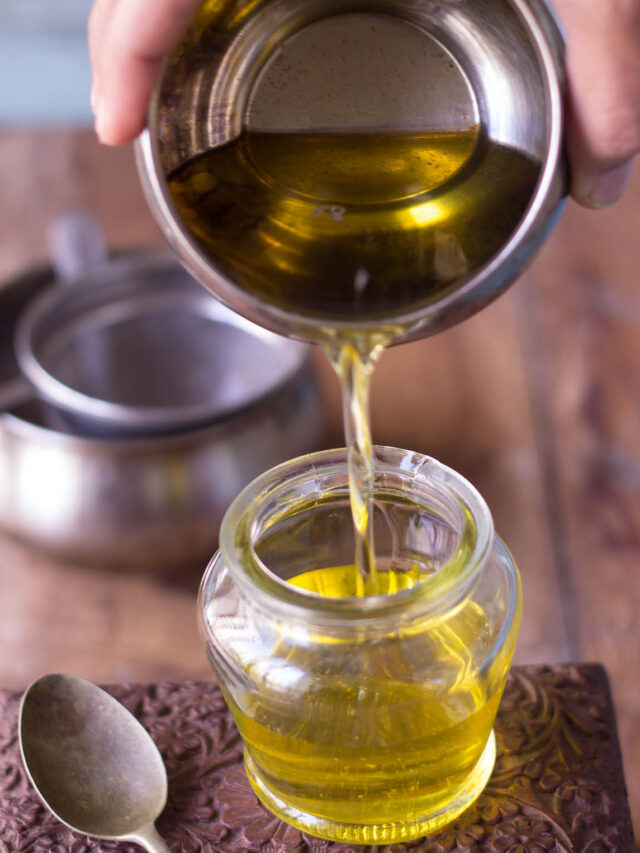 Freshly strained ghee, clear and golden, in a glass jar