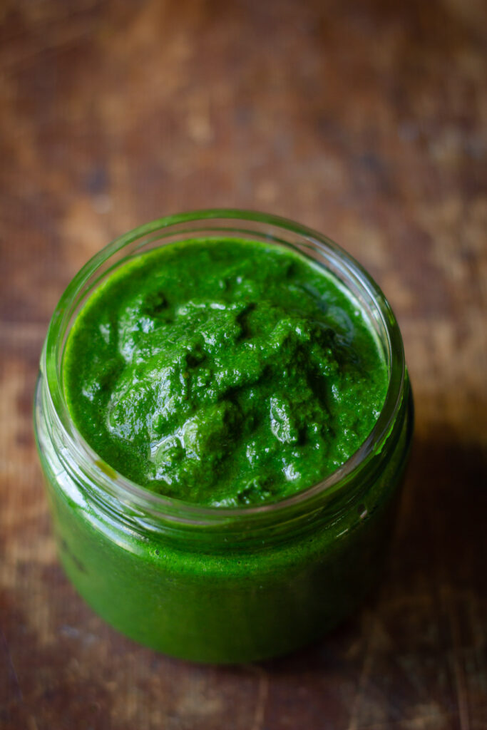 Close-up of the vibrant green mint coriander chutney kept in a jar