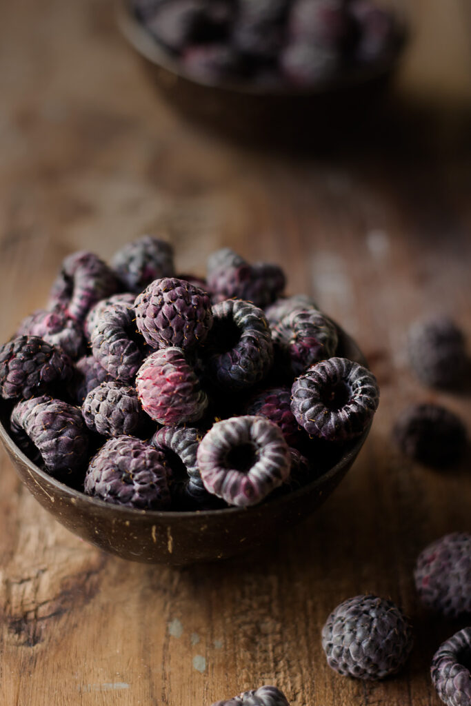 Fresh raspberries on a wooden table, rich in vitamin C