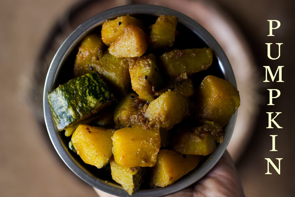Cooking process of khatta meetha kaddu in a plate with spices and pumpkin chunks
