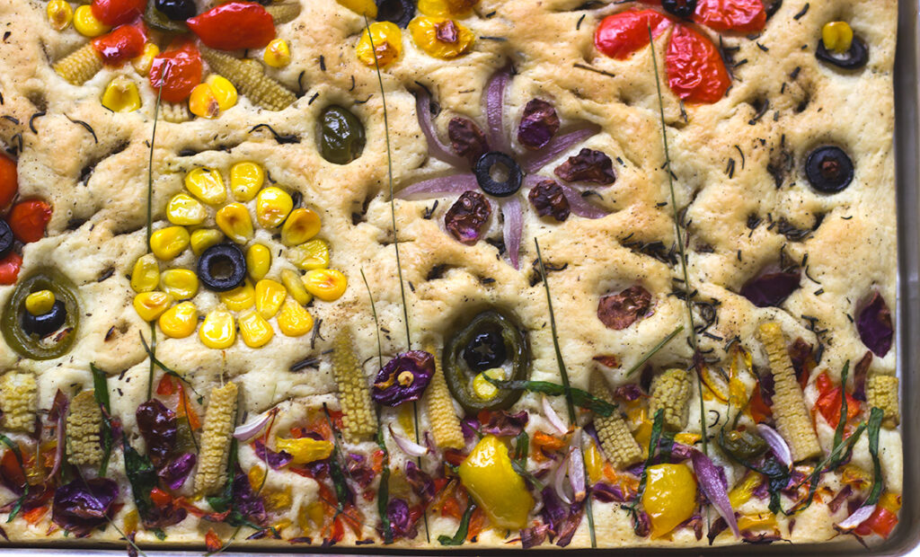 A table setting with garden focaccia as the centerpiece