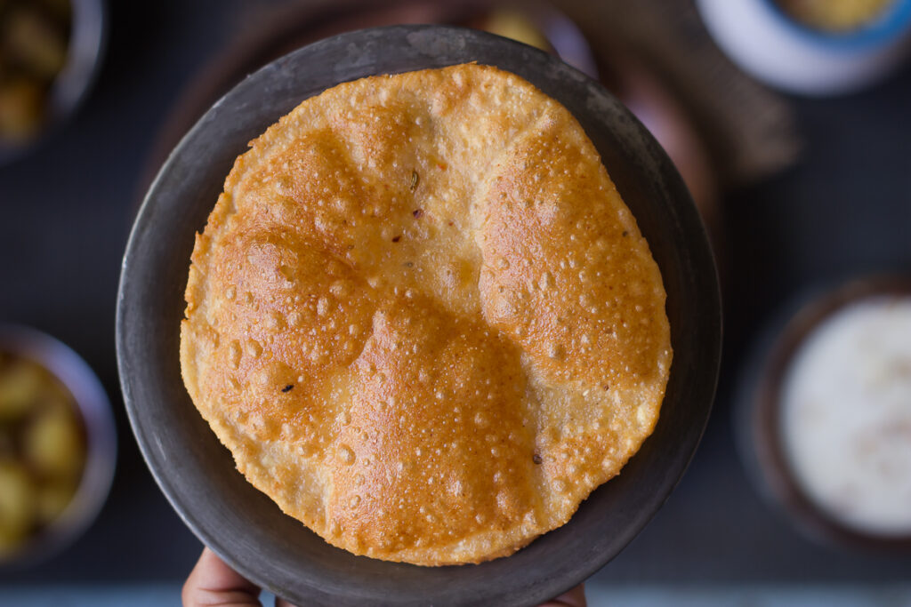 Close-up of a freshly fried Bedmi Puri showing its crispy texture