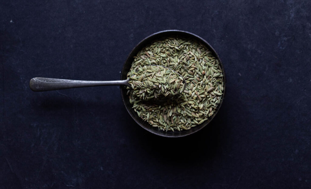 A close-up of coriander powder’s natural golden-green hue