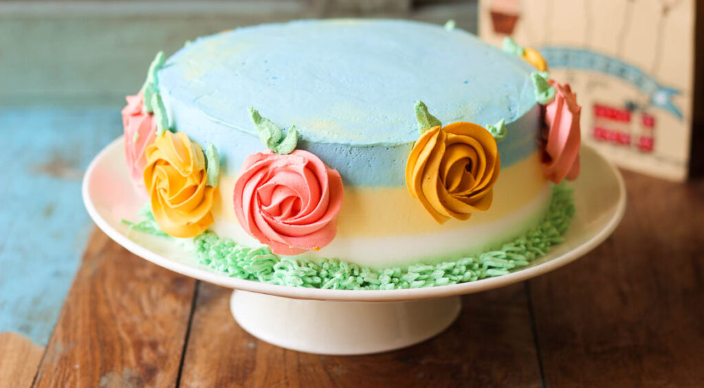 Eggless mango cake topped with fresh mango cubes